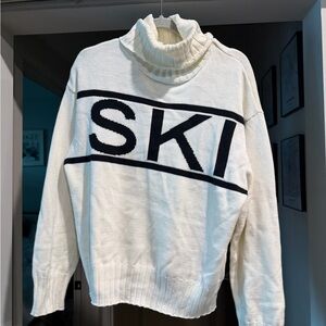 Cozy Cream Turtleneck Sweater with Black Lettering